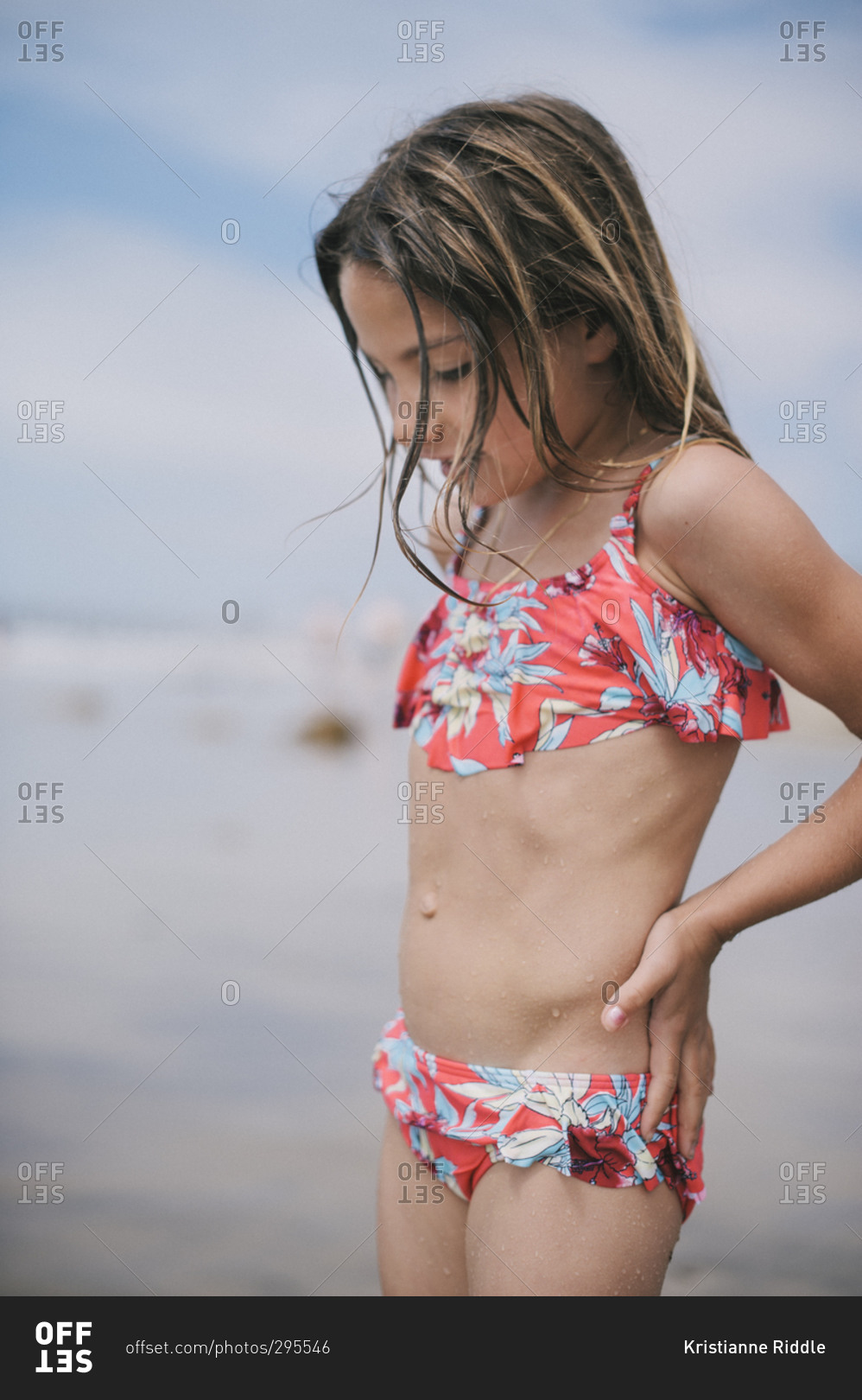 Little Girl Standing On A Beach Stock Photo Offset