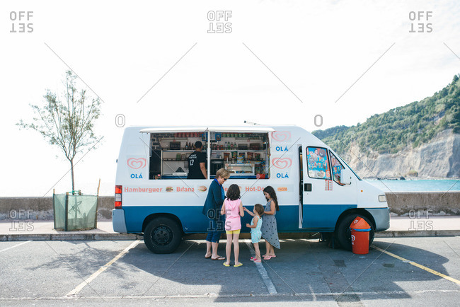 Sao Miguel Island, Portugal - October 13, 2015: Girls getting treats from the ice cream truck, Sao Miguel Island, Portugal