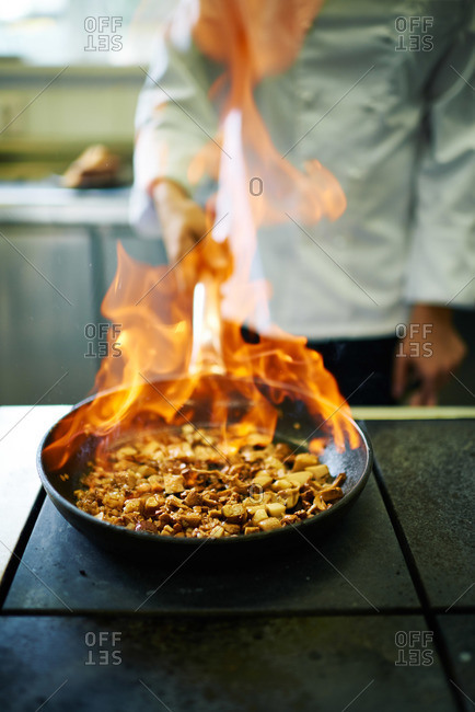Chef flambeing a dish in restaurant