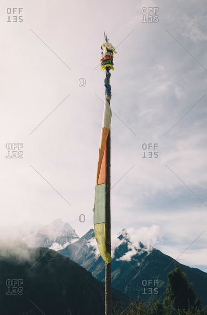A prayer flag stands tall in the Everest Region in monsoon season in Nepal