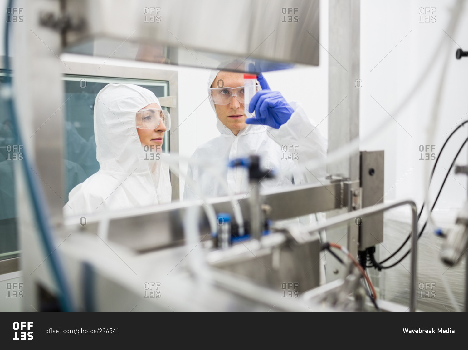 Scientists working with large vat in the lab