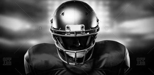 Close Up Of Serious American Football Player In Red Jersey Looking Down Against Sports Pitch Stock Photo Offset