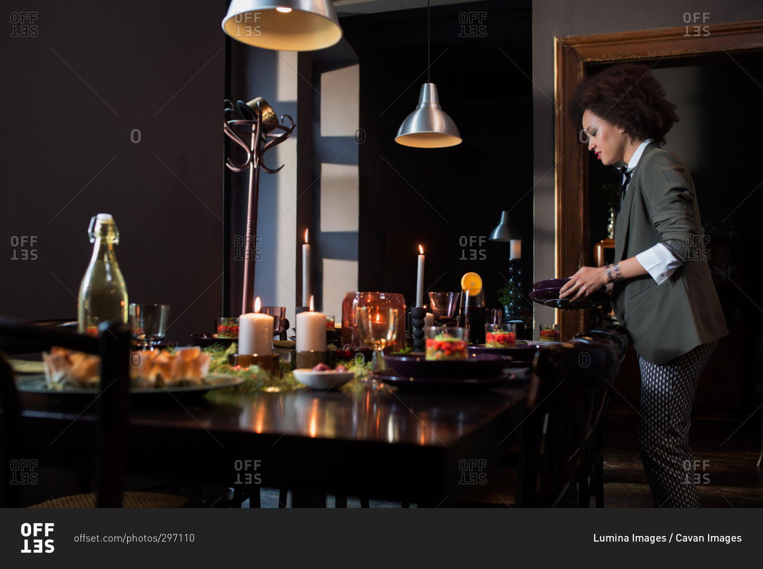 Woman setting the table for a holiday dinner party