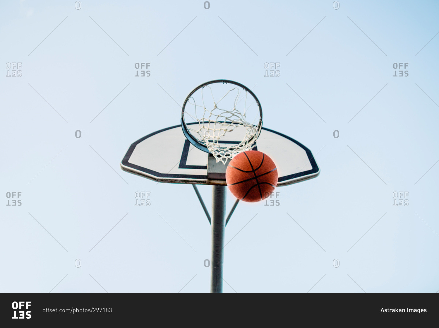 Basketball making a basket through the hoop