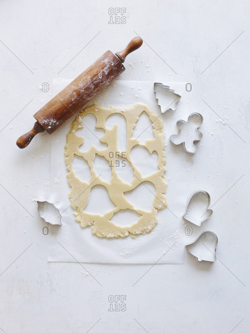 Rolled dough cut out with cookie cutters for Christmas cookies