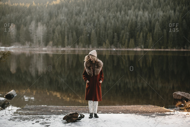 Woman turning head by winter lake