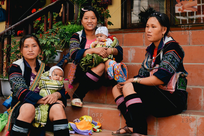 Sapa, Vietnam - July 13, 2015: A group of women take a rest on the stairs of a local store