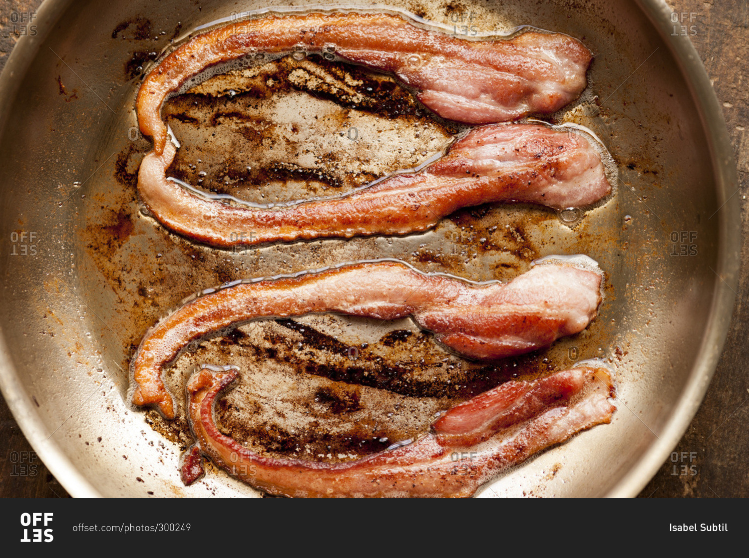 Closeup of strips of bacon in skillet
