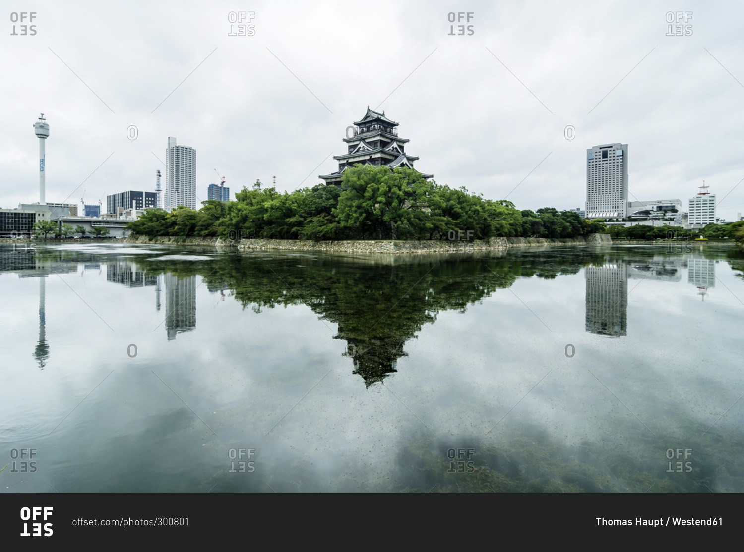 Traditional Japanese tower flanked by modern skyline