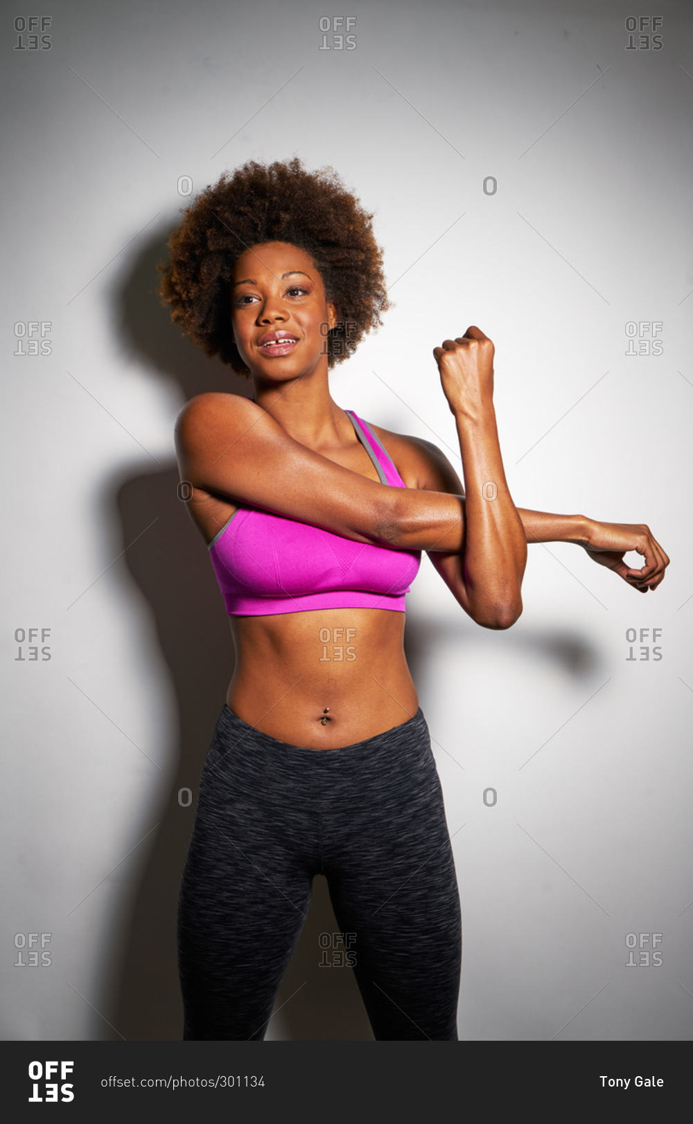 Young athletic woman stretching her arms
