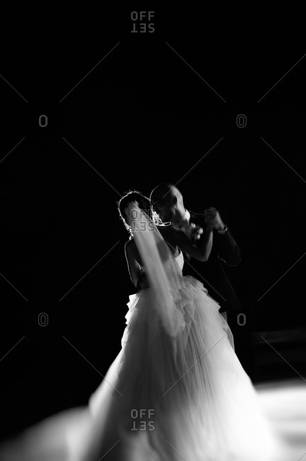 Newlywed couple dancing in glowing light