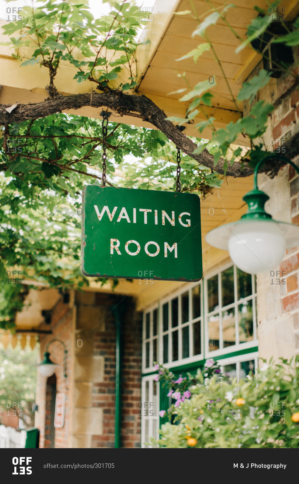 Waiting room sign at vintage train station stock photo - OFFSET