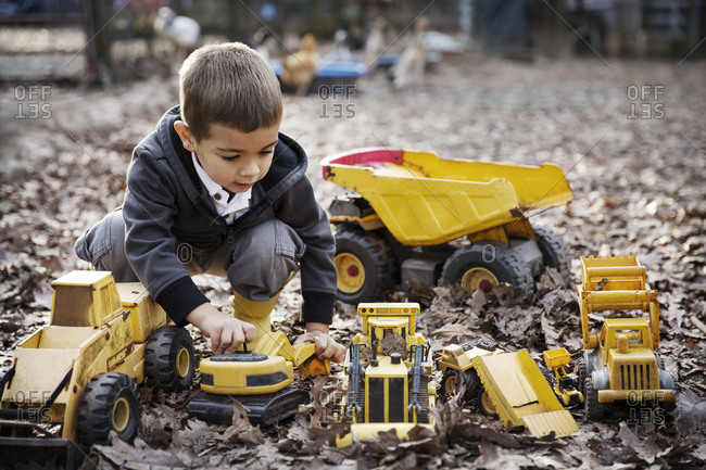 Kids playing with store toy trucks