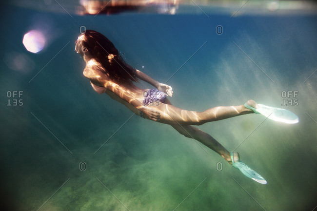 Woman with flippers swimming in sea