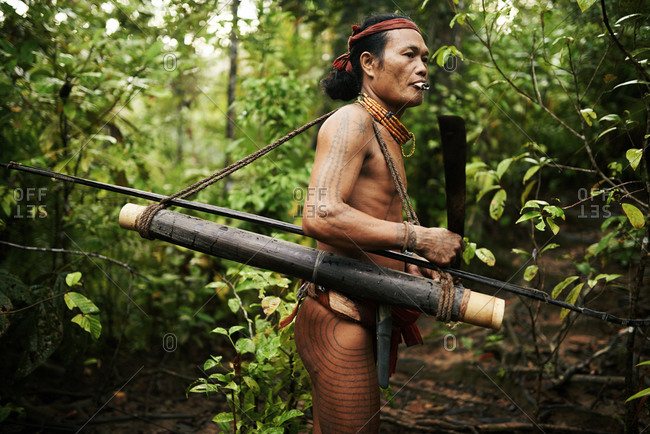 November 21, 2013: Portrait of a Mentawai hunter with weapon in jungle