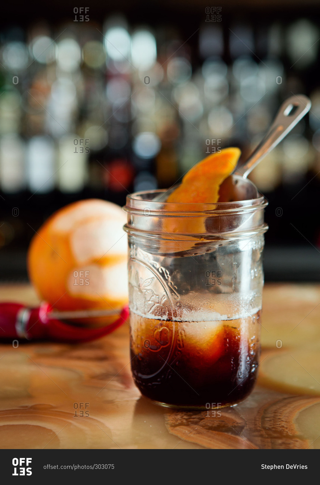 Orange peel garnishing an old fashioned cocktail stock photo OFFSET