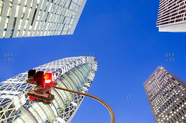 Tokyo, Japan - November 24, 2015: Low angle view of traffic light and Shinjuku Office Towers in Tokyo, Japan