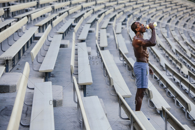 Male athlete drinking from sports bottle