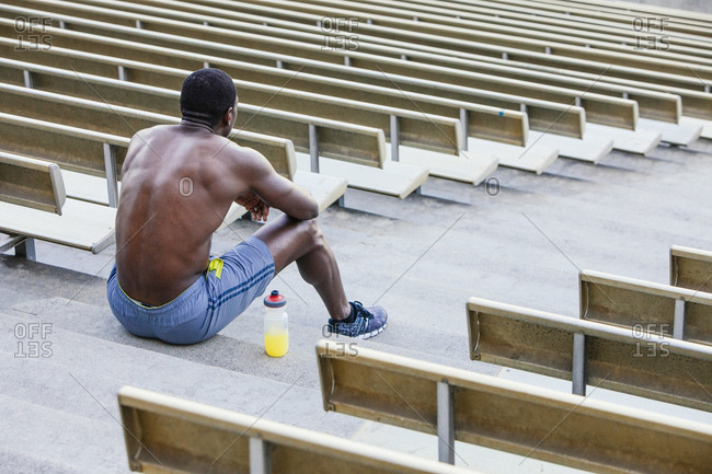 Athlete sitting on stadium steps
