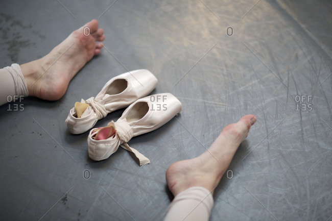 Ballet dancer's bare feet and slippers 