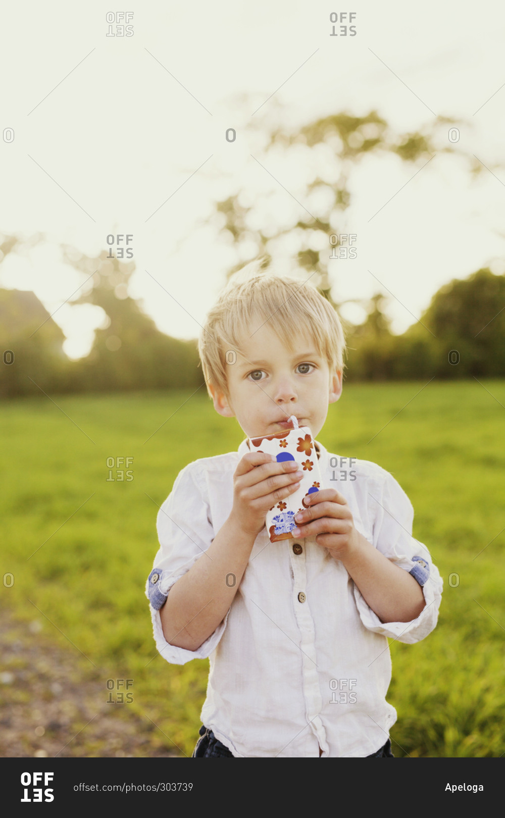 Little boy drinking a juice box