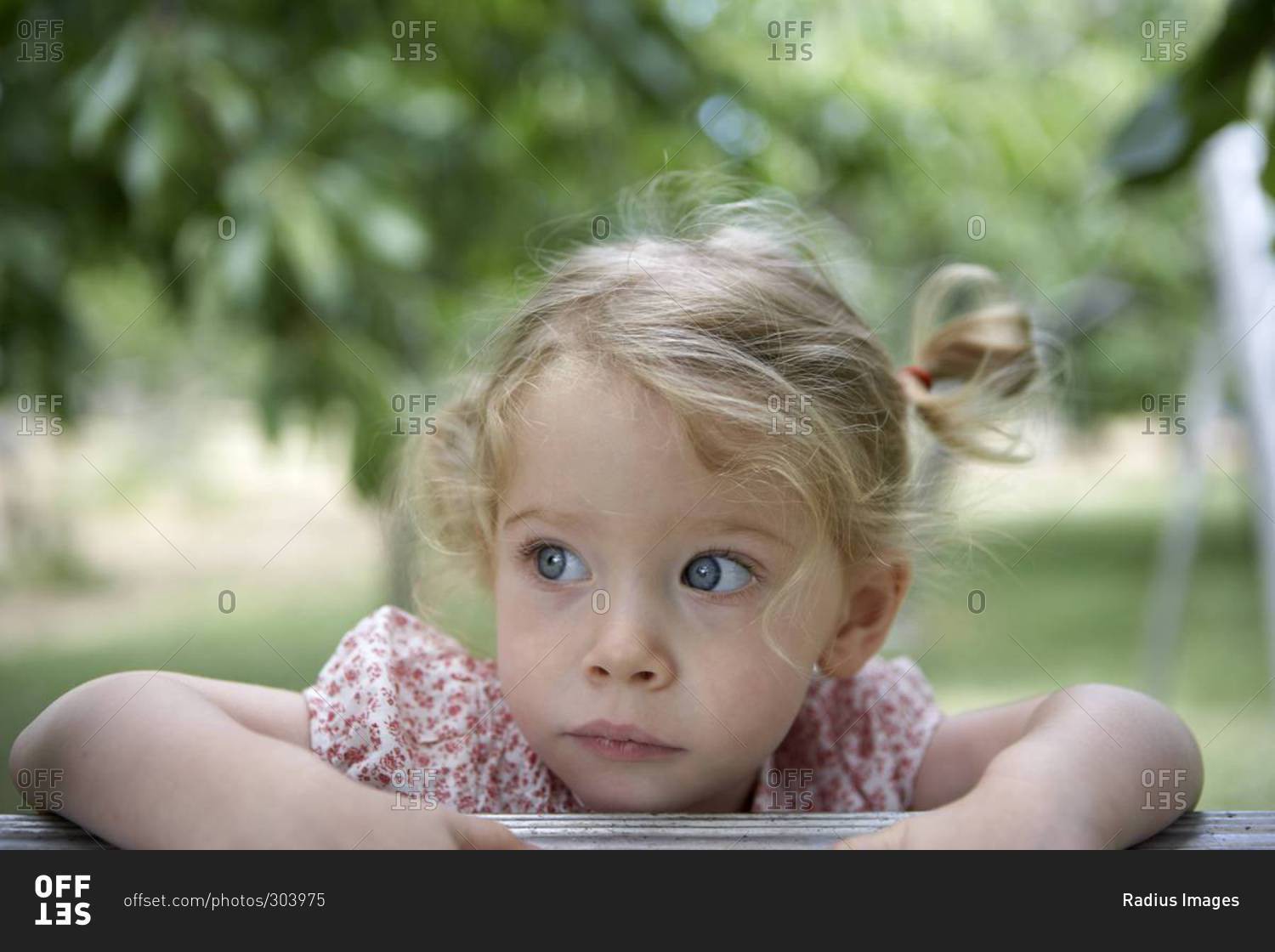 Portrait of girl leaning over a rail stock photo - OFFSET