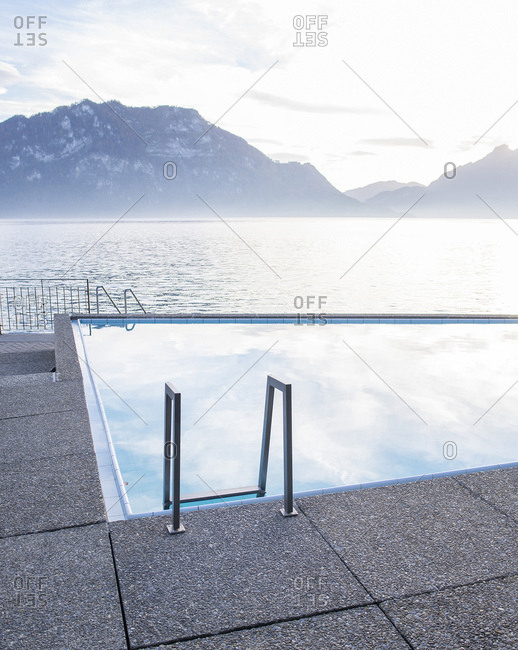 Swimming pool beside a lake and mountains