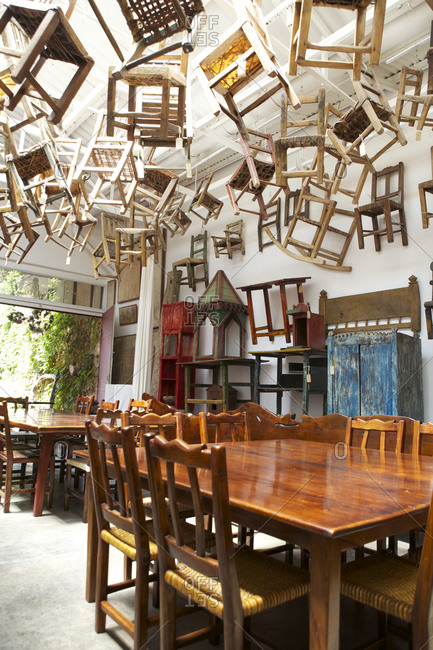 Buenos Aires, Argentina - November 9, 2010: Chairs hanging from ceiling above dining tables and chairs