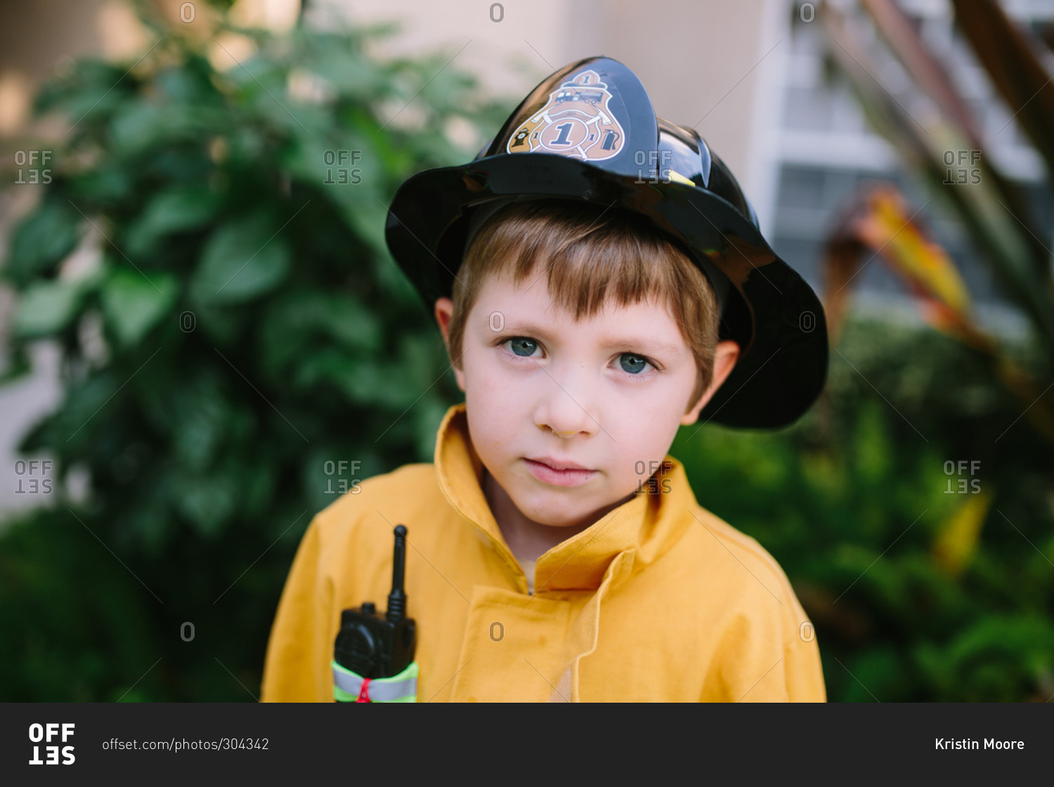 Portrait of young boy in fireman costume