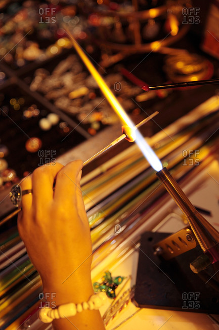 Woman making glass jewelry