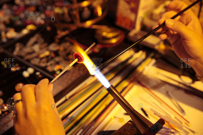 Woman making glass jewelry