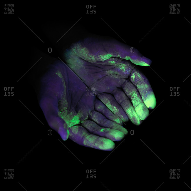 Ultraviolet (UV) light showing bacteria on a person's hands