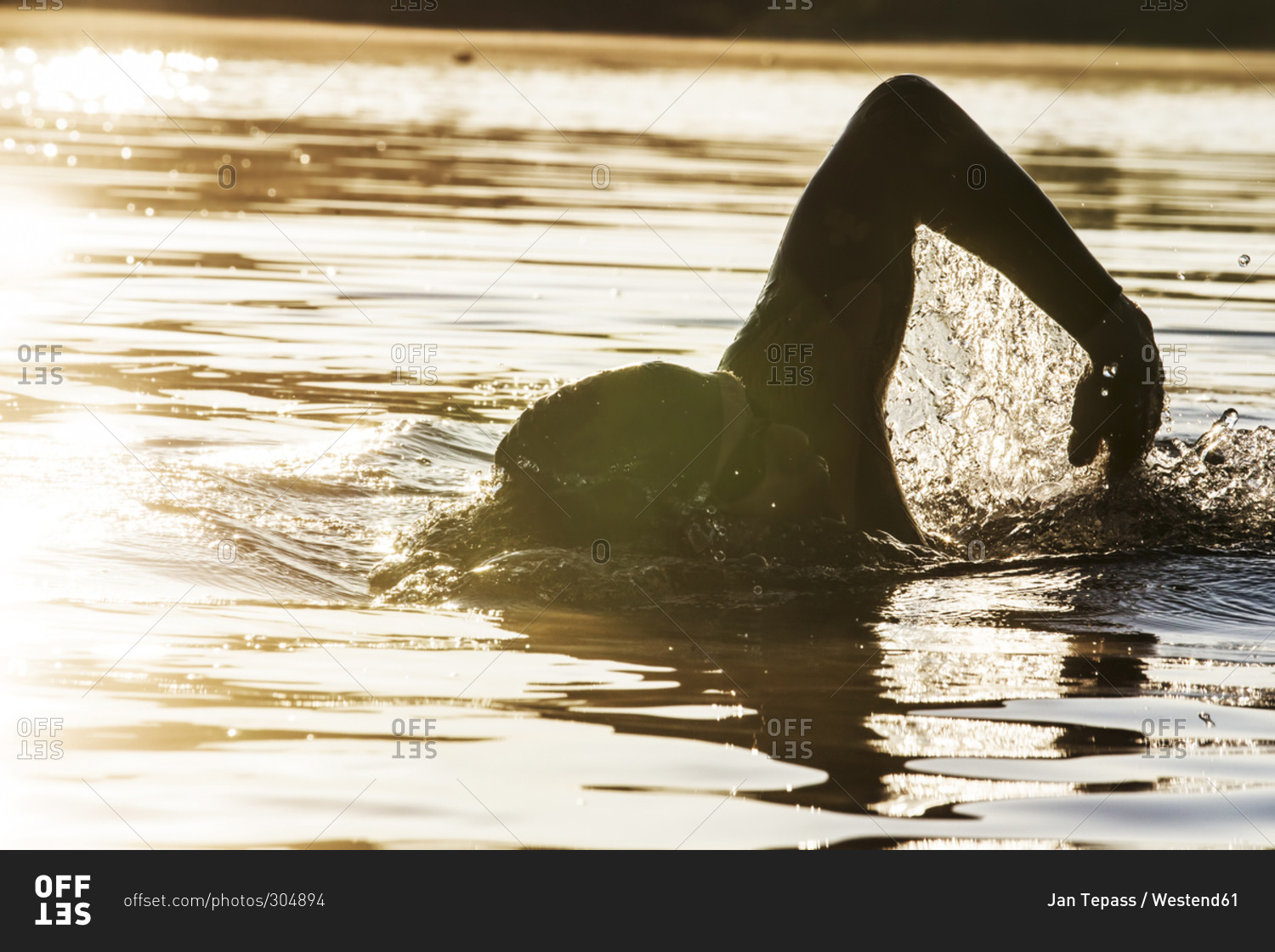 Triathlete swimming in lake