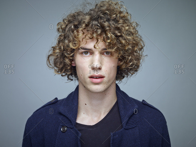 Portrait Of Young Man With Curly Blond Hair Stock Photo Offset