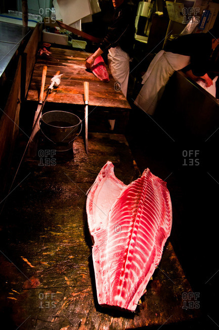 Fresh cut fish meat on a cutting board at the Tsukiji Market