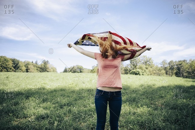 Woman holding up an American flag
