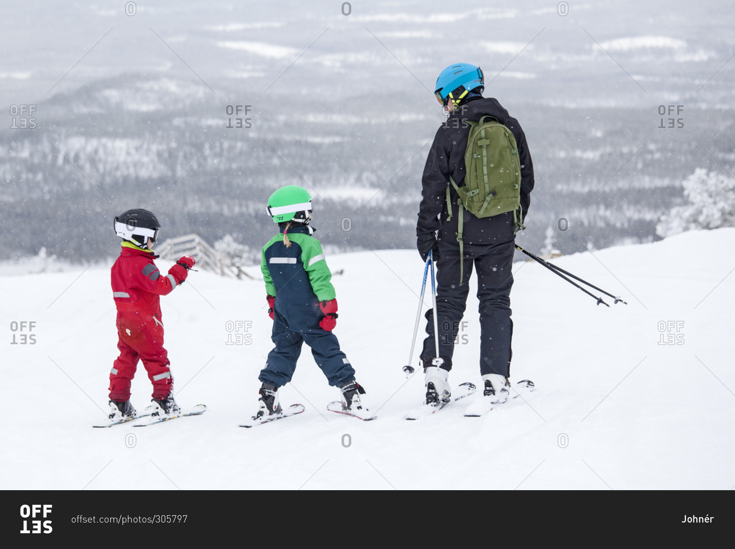 Father with children skiing