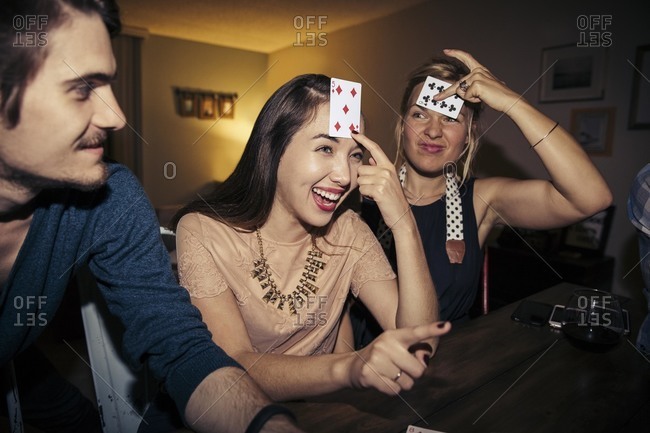 Friends playing a card game at party