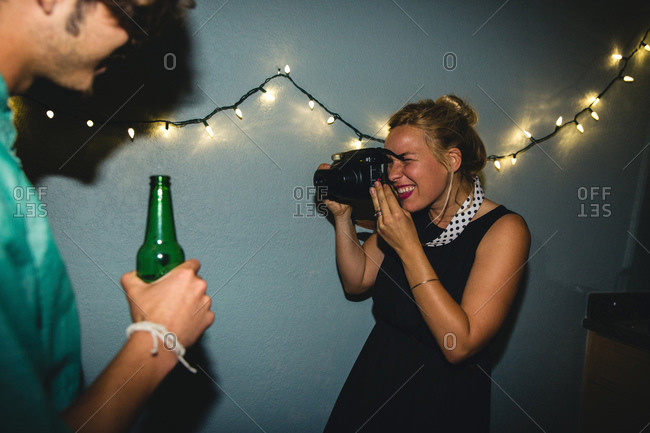 Woman taking photo with camera at party