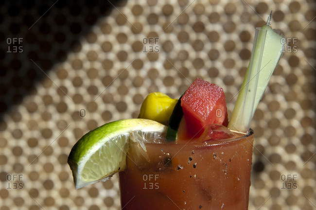A Bloody Mary garnished with watermelon, celery and lime