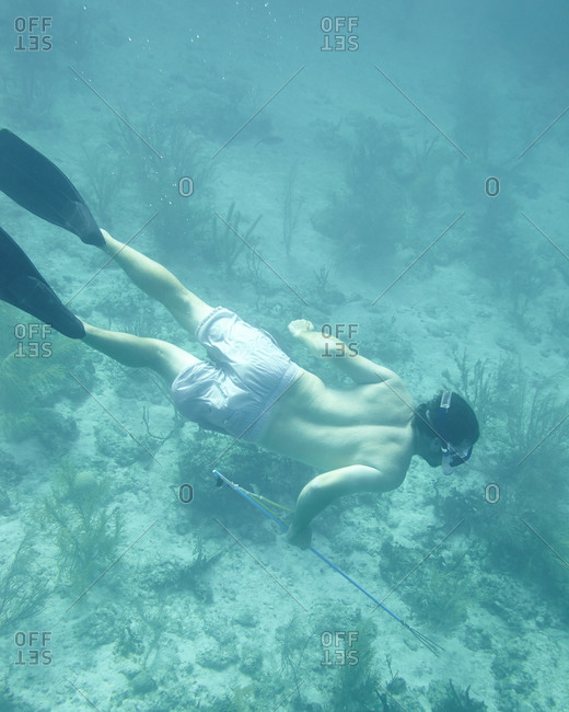 Person spearfishing in the Bahamas