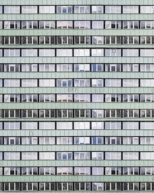 Full frame view of rows of windows on an apartment building