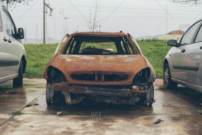 Burnt out car in a parking lot