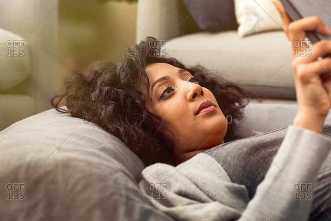Woman on cushions with tablet