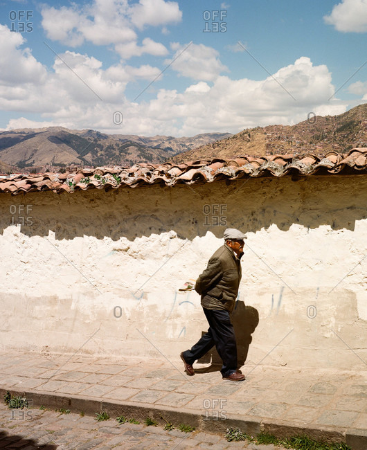 Cusco, Peru - December 22, 2015: Man walking along sidewalk