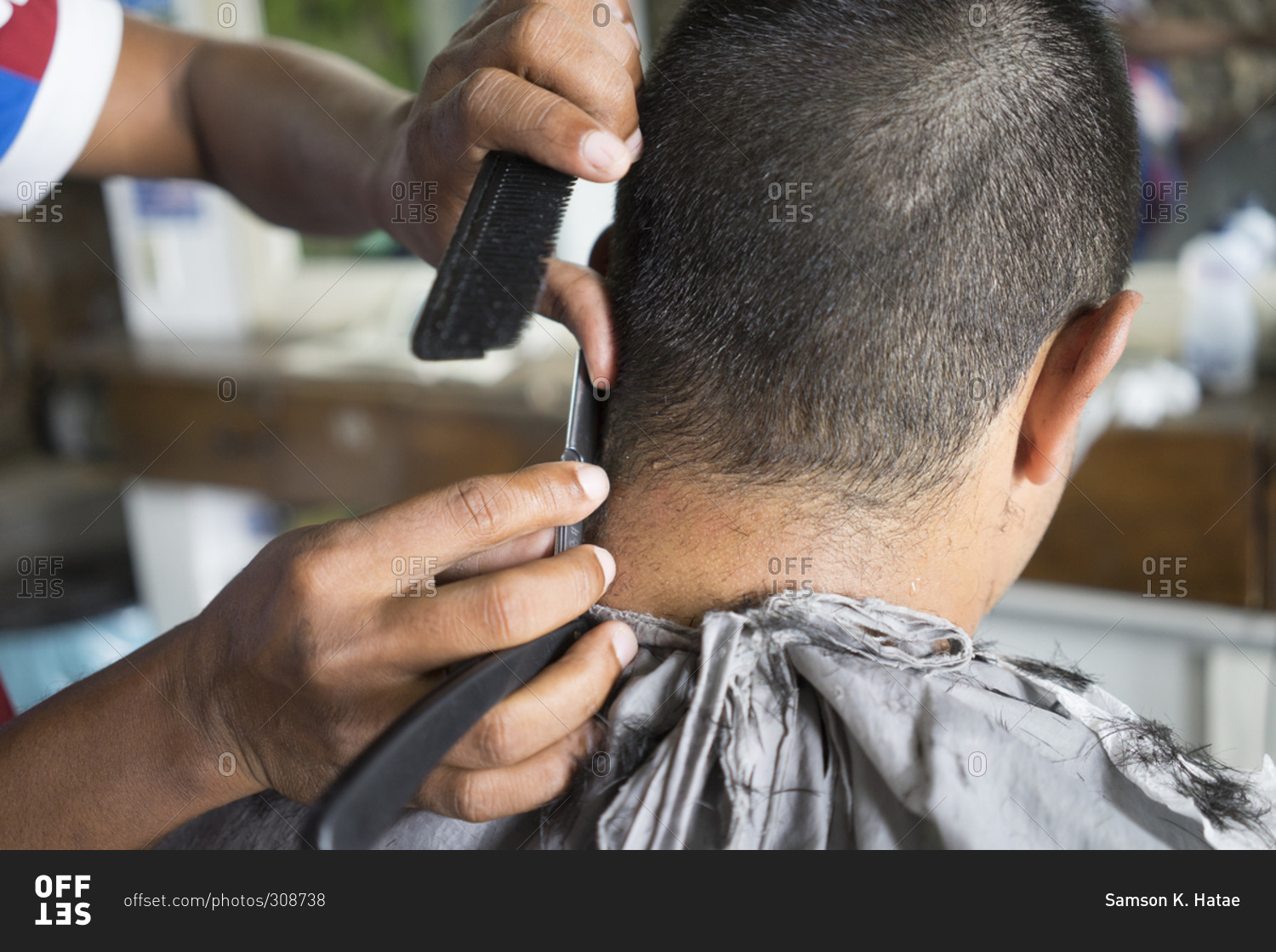 Barber using a straight razor to trim a customer's hair stock photo