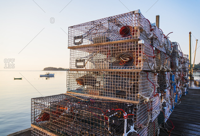 Stacks of lobster traps at sunrise