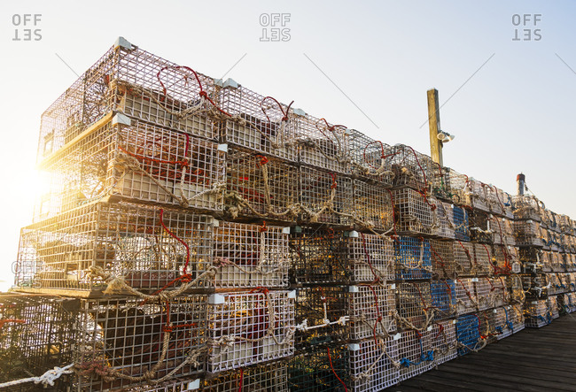 Stacks of lobster traps against clear sky