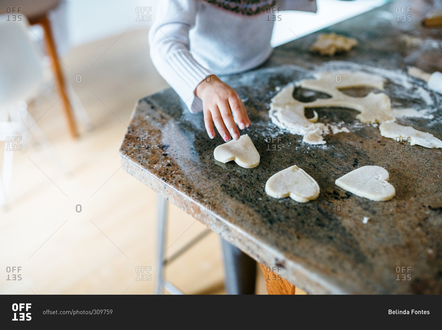 Girl making Valentine heart cookies