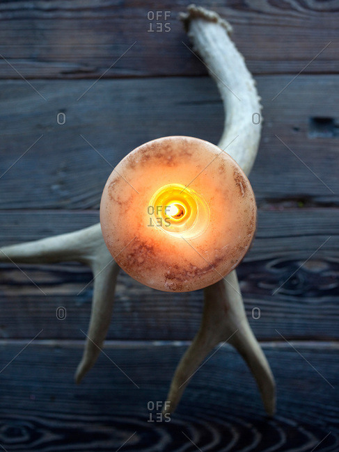 Candle on antler candle holder on table